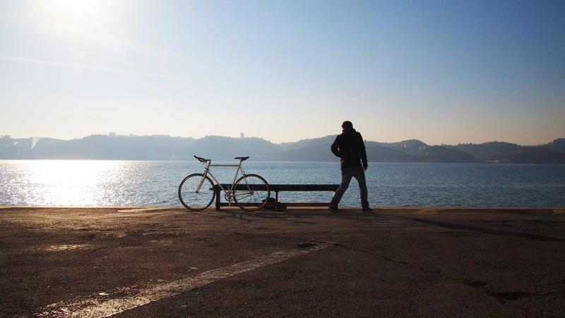 Trader reflecting on trades with journal and charts